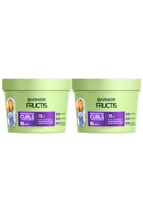 Two light green tubs of Garnier Fructis Method for Curls Mask are displayed. Each tub is labeled "METHOD FOR CURLS UP TO 1 WEEK OF MOISTURE," indicating it's a "MASK" with "13% HYALURONIC MOISTURE COMPLEX + SHEA FATTY ACIDS." It also states "NO SULFATES, NO SILICONES, NO ARTIFICIAL COLORANTS."